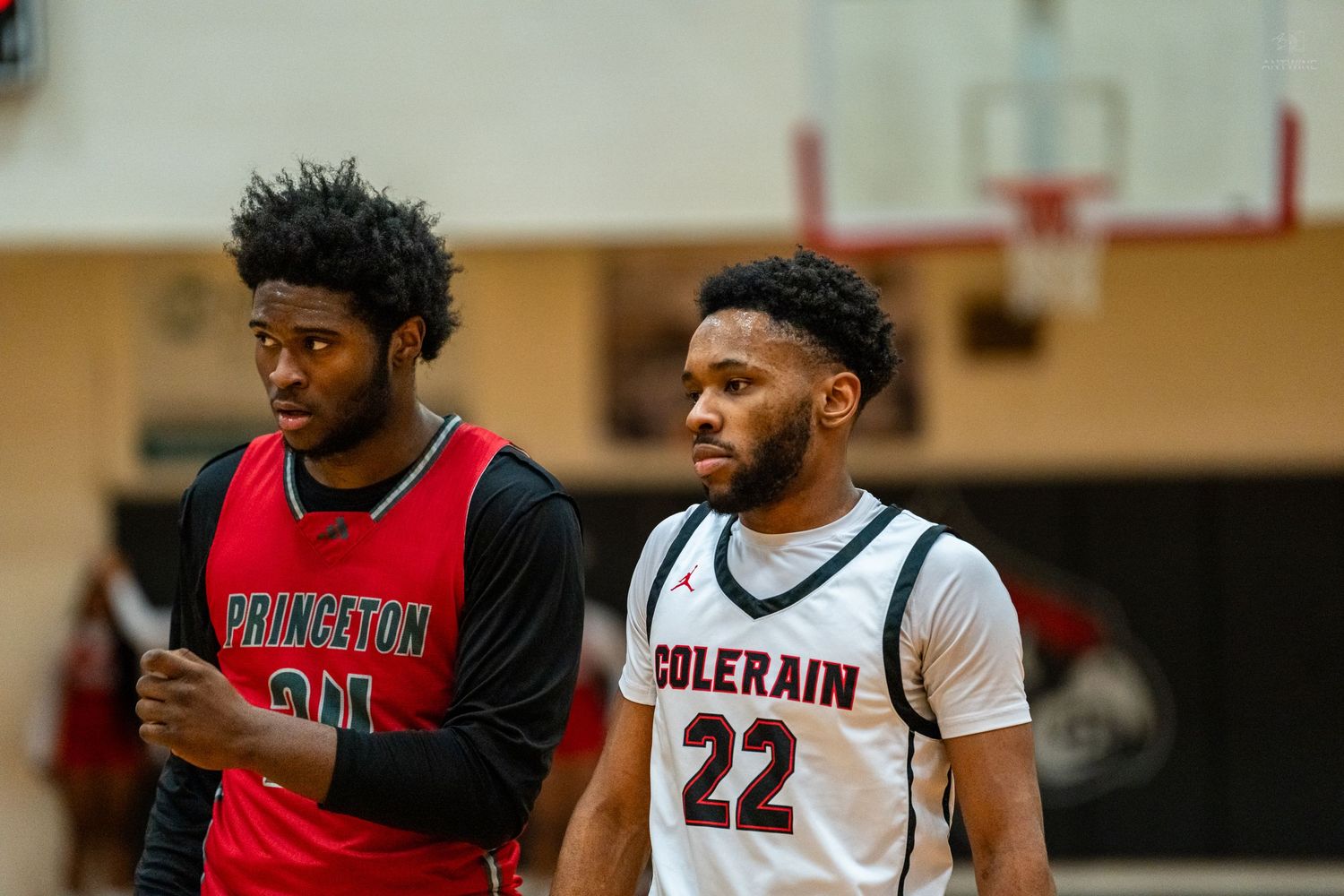 Princeton and Colerain High School basketball players stand together during a game break.