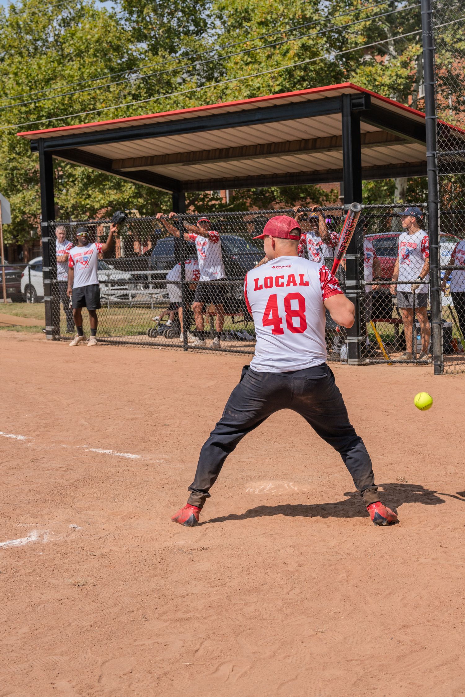Softball batter in Local 48 jersey preparing to hit during a recreational league game.