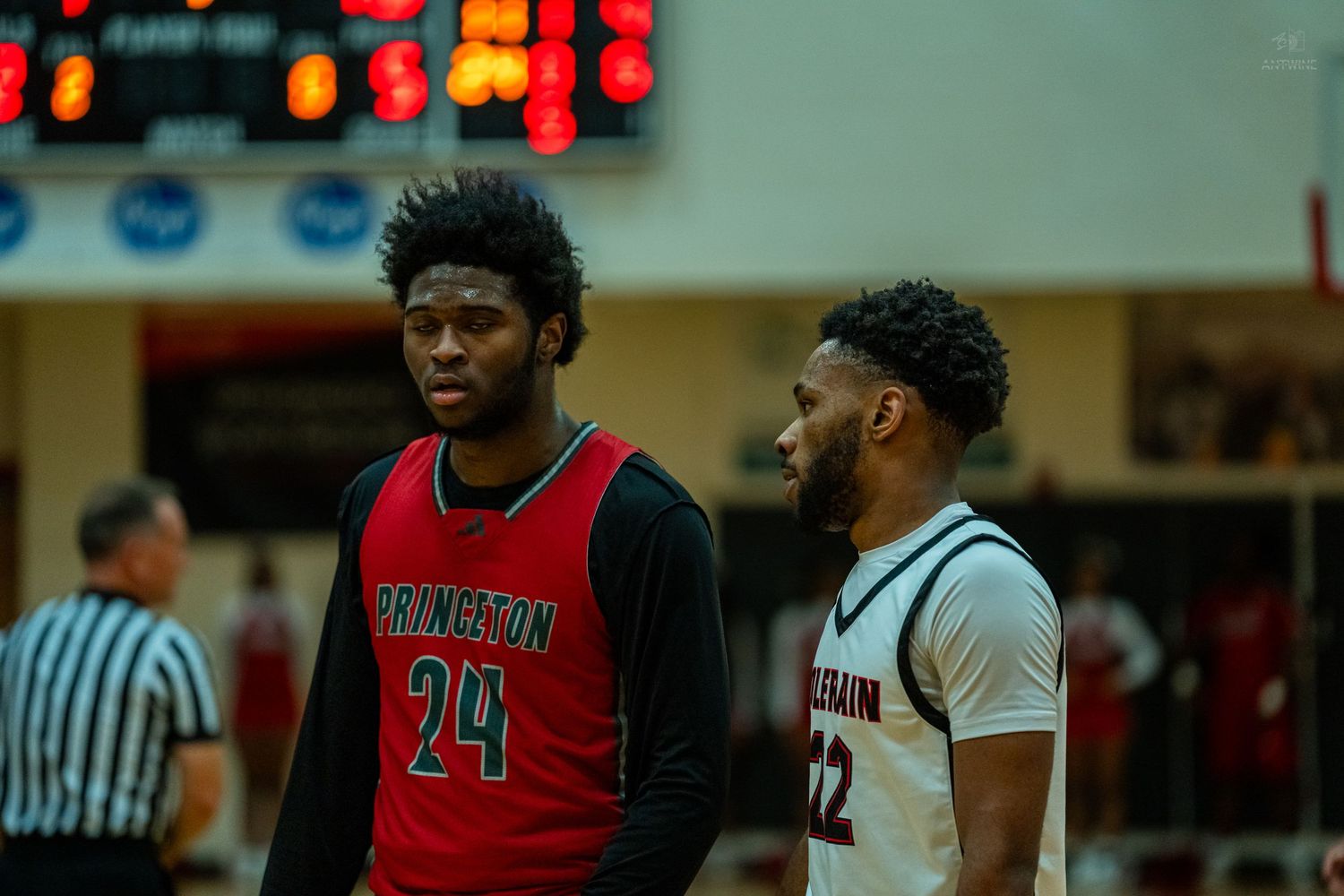 Princeton number 24 and Colerain number 22 players chat during a high school basketball game.