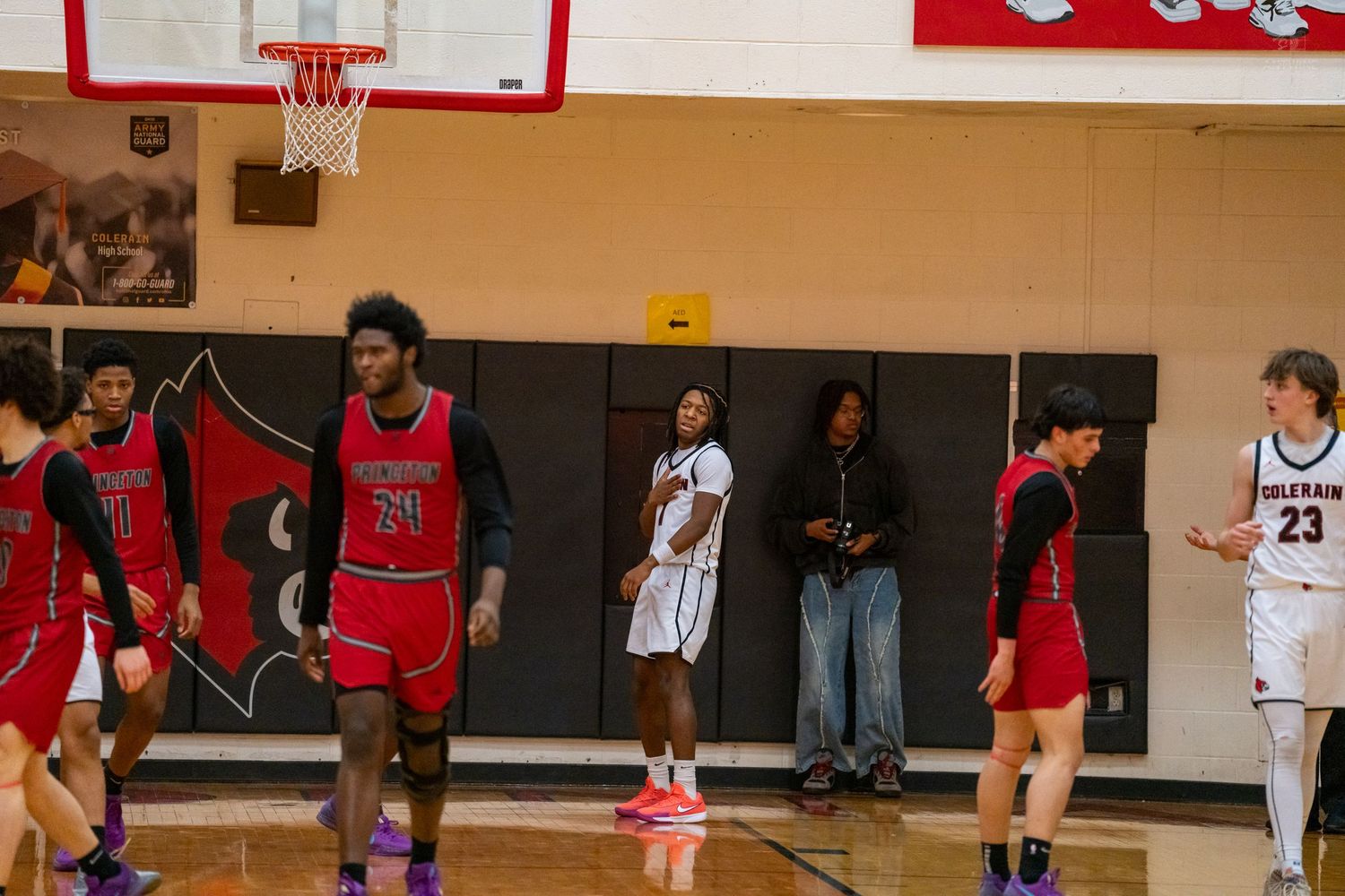 High school basketball players stand on the court during a game at Colerain gymnasium.