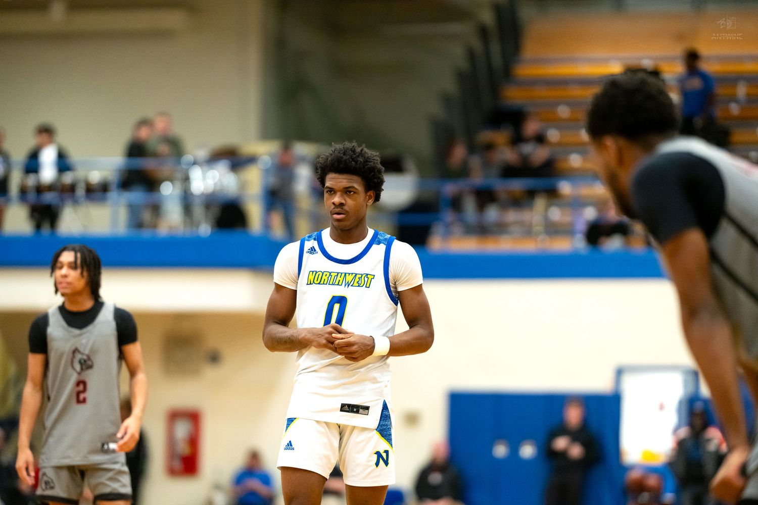 High school basketball player number 0 in blue Northwest uniform during a game.