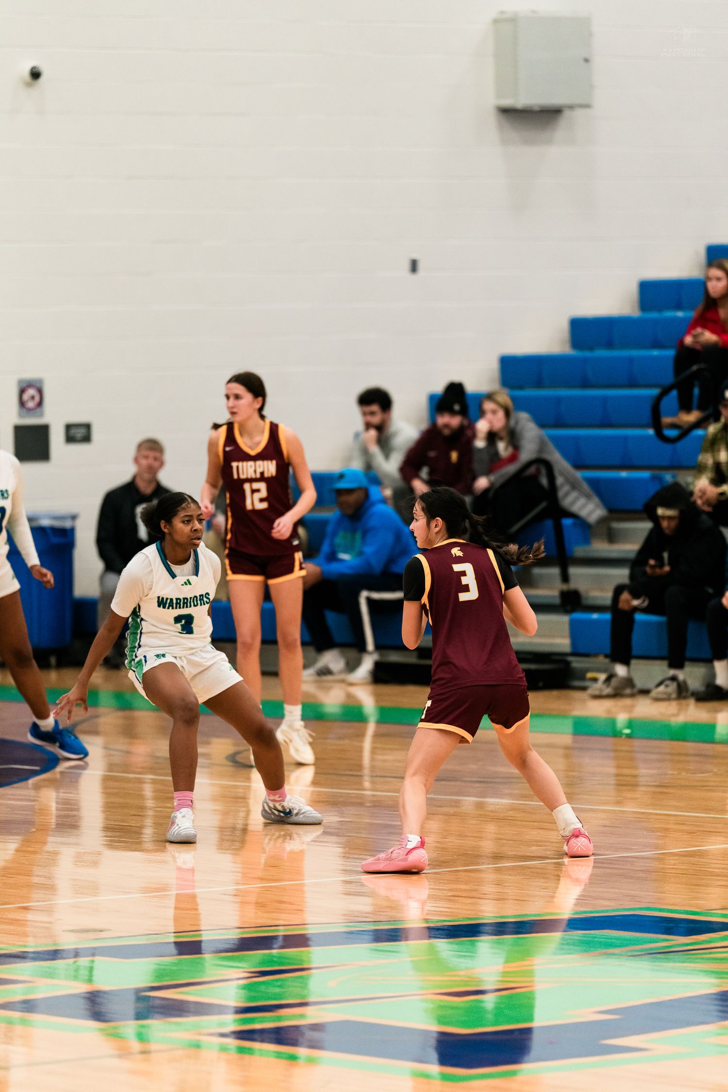 Warriors player guards Turpin number 3 during girls high school basketball game.
