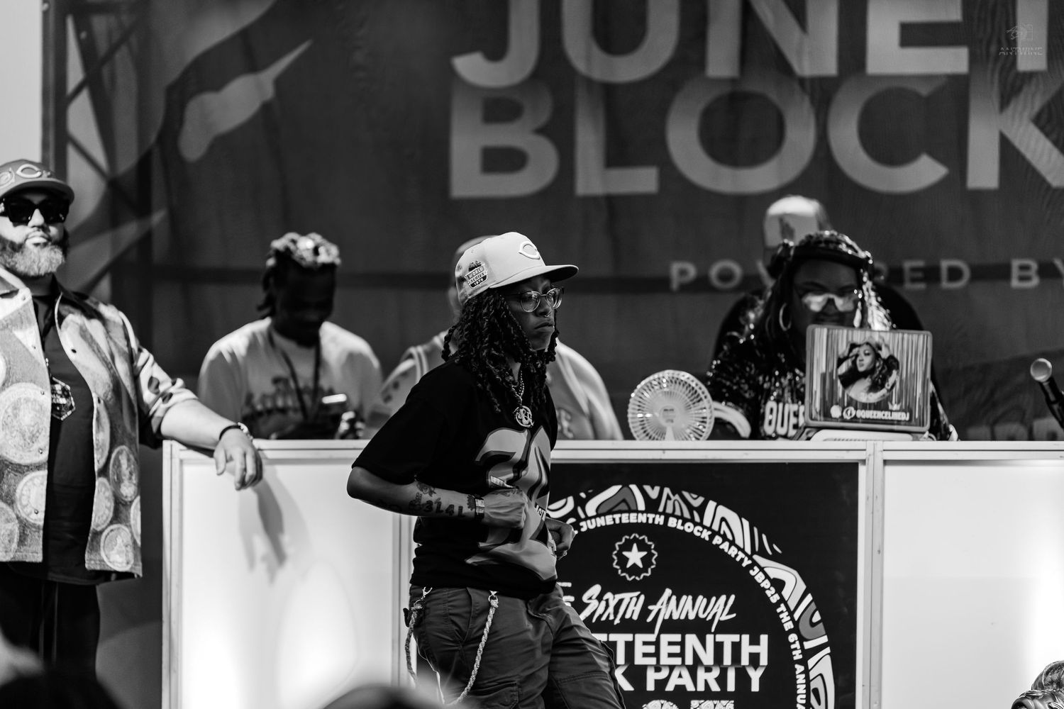People performing on stage at the 6th Annual Juneteenth Block Party outdoor event.
