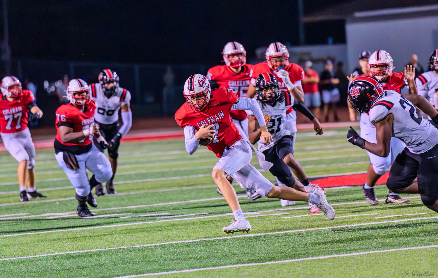 Colerain ball carrier breaks through the line of scrimmage during an exciting high school football game.