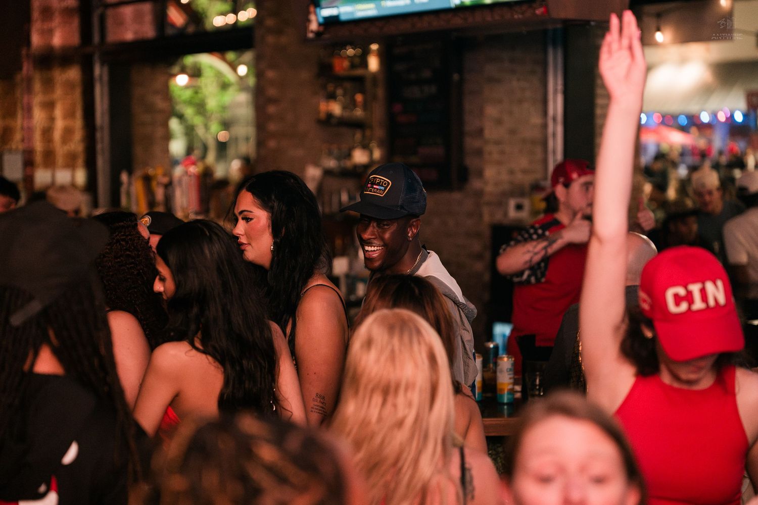 Group of women laughing and dancing together at a lively nightclub party.