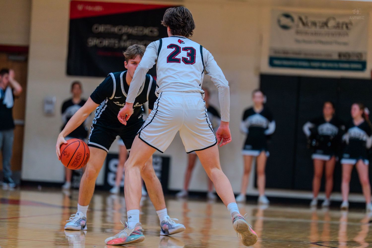 Lakota East player dribbles against Colerain #23 defender in high school game.