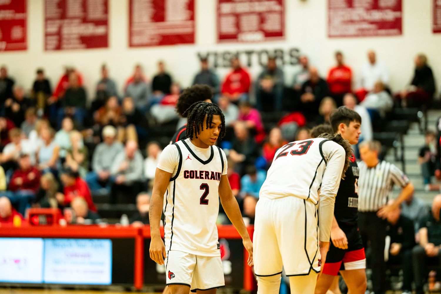 Colerain basketball player #2 stands on court during packed high school basketball game.