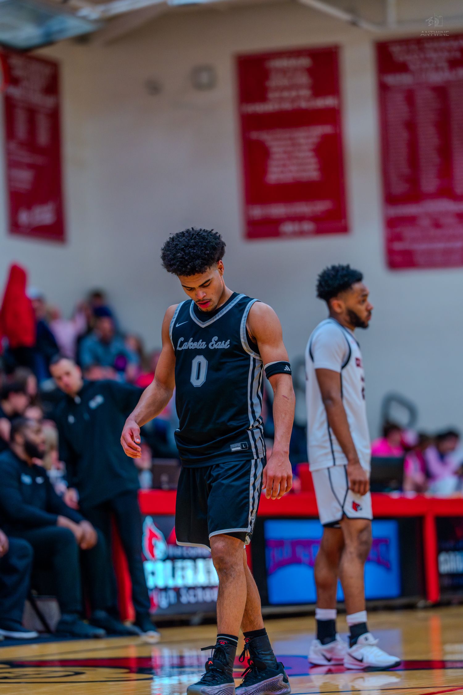 Player wearing number 0 for Colerain East walks on a high school basketball court during a game.