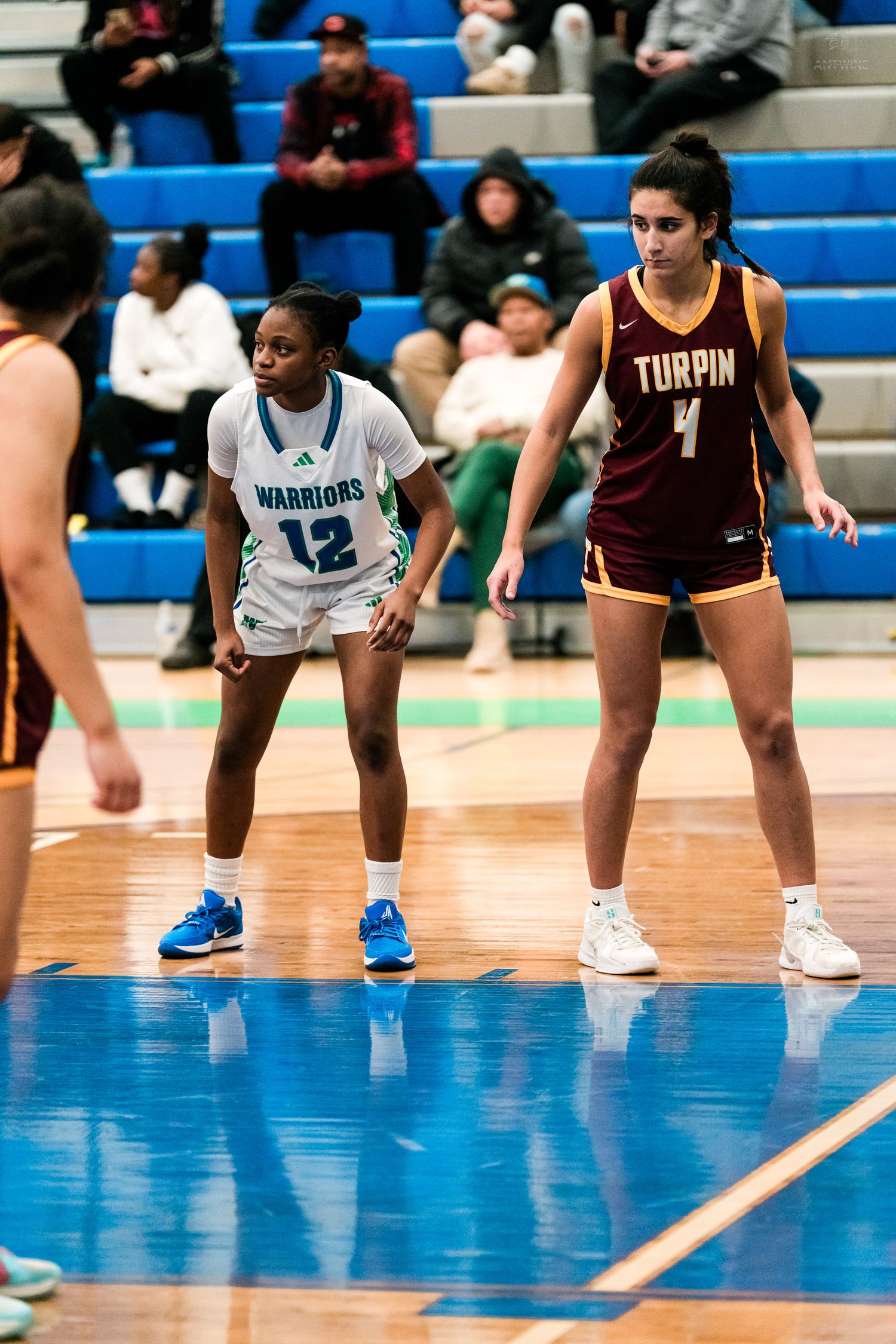 Warriors #12 and Turpin #4 prepare during a girls high school basketball free throw.