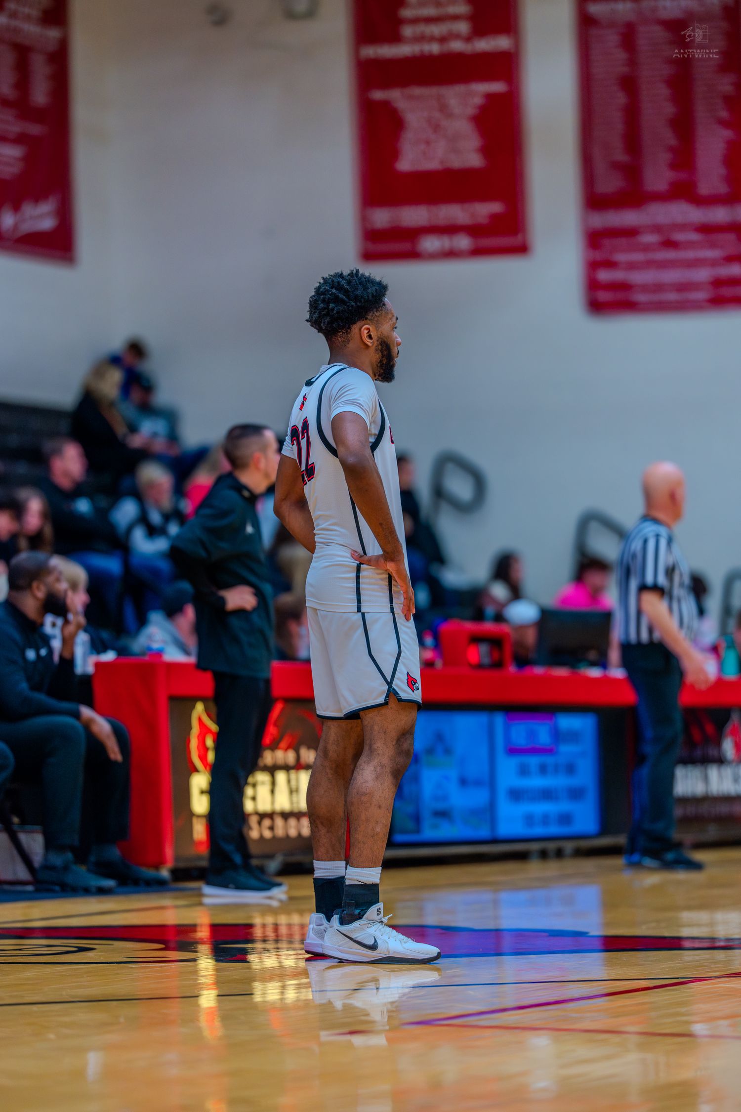 Colerain high school basketball player stands on the court during a game in the gym.