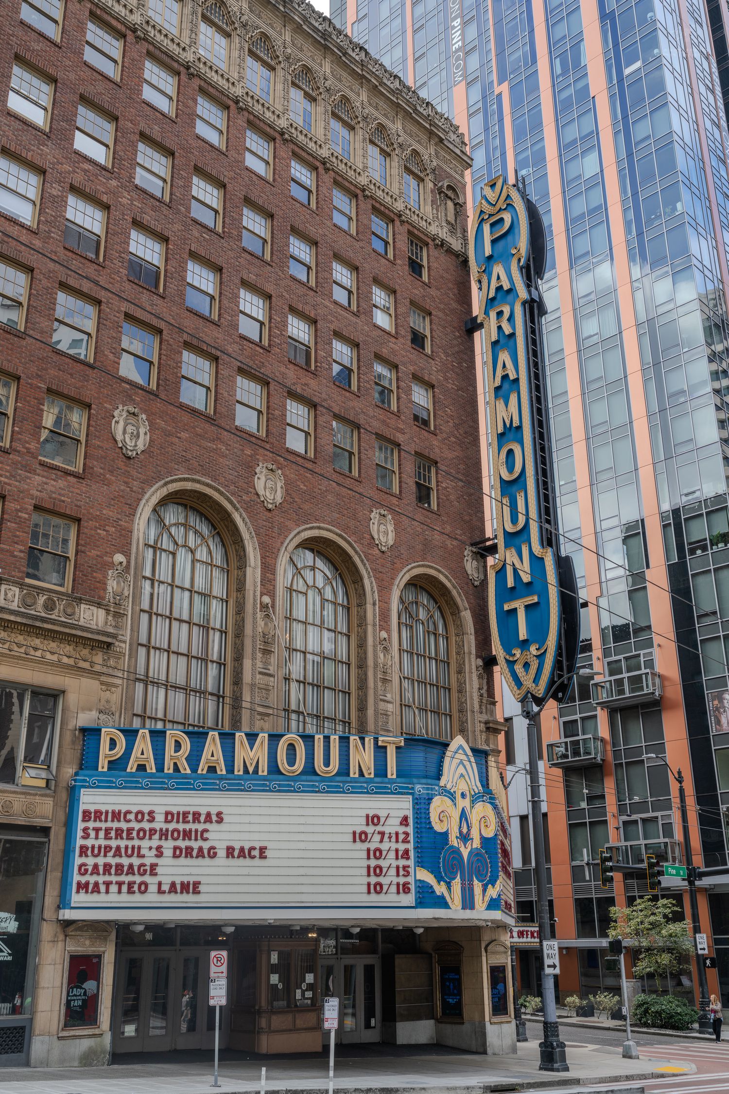 Paramount Theatre marquee in Seattle displaying upcoming shows including Garbage and RuPauls Drag Race on a brick building.