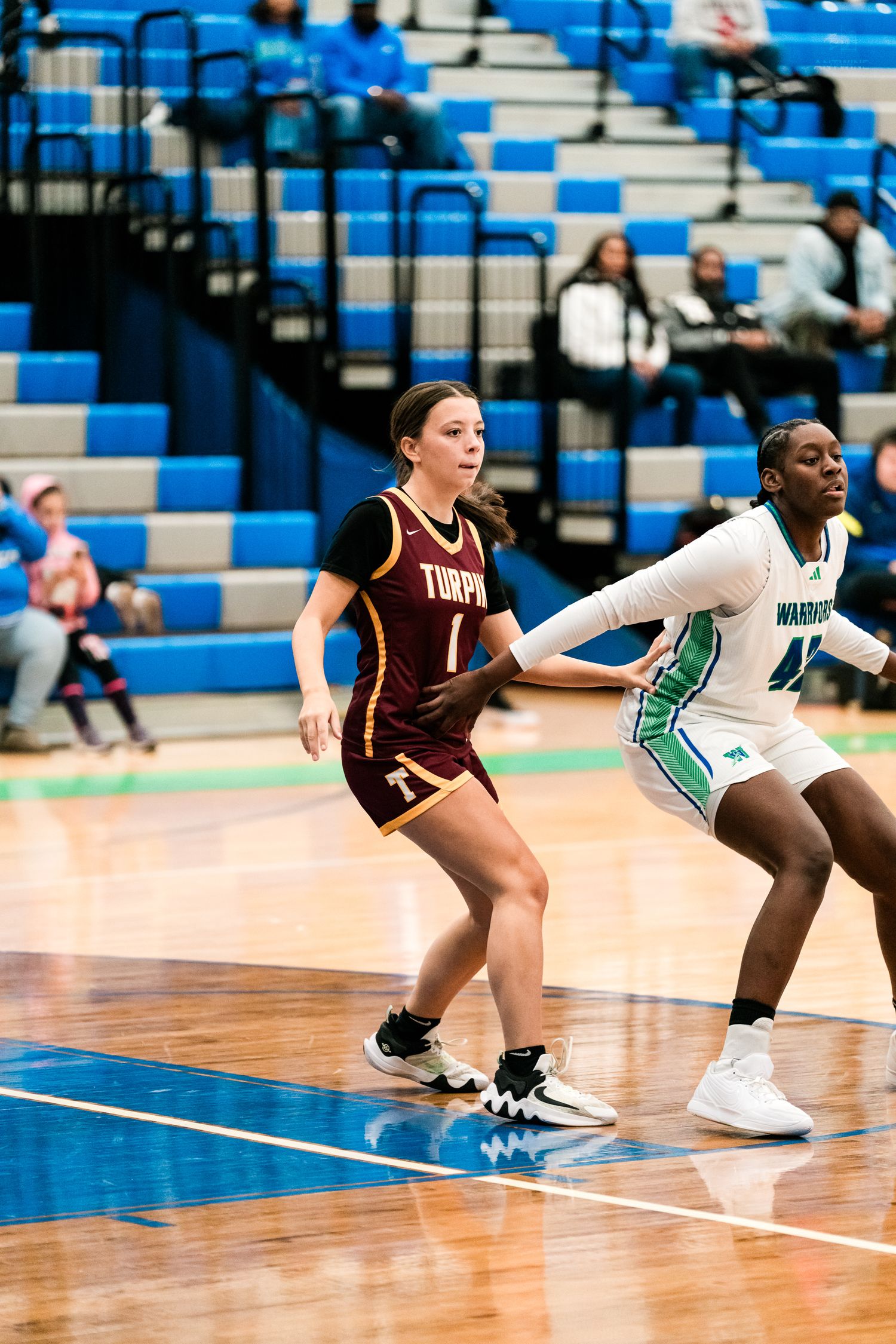 Turpin #1 and Warriors player battle for position in a girls high school basketball game.