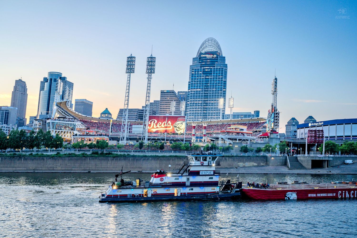 Cincinnati skyline with Great American Ball Park viewed from the Ohio River at dusk.