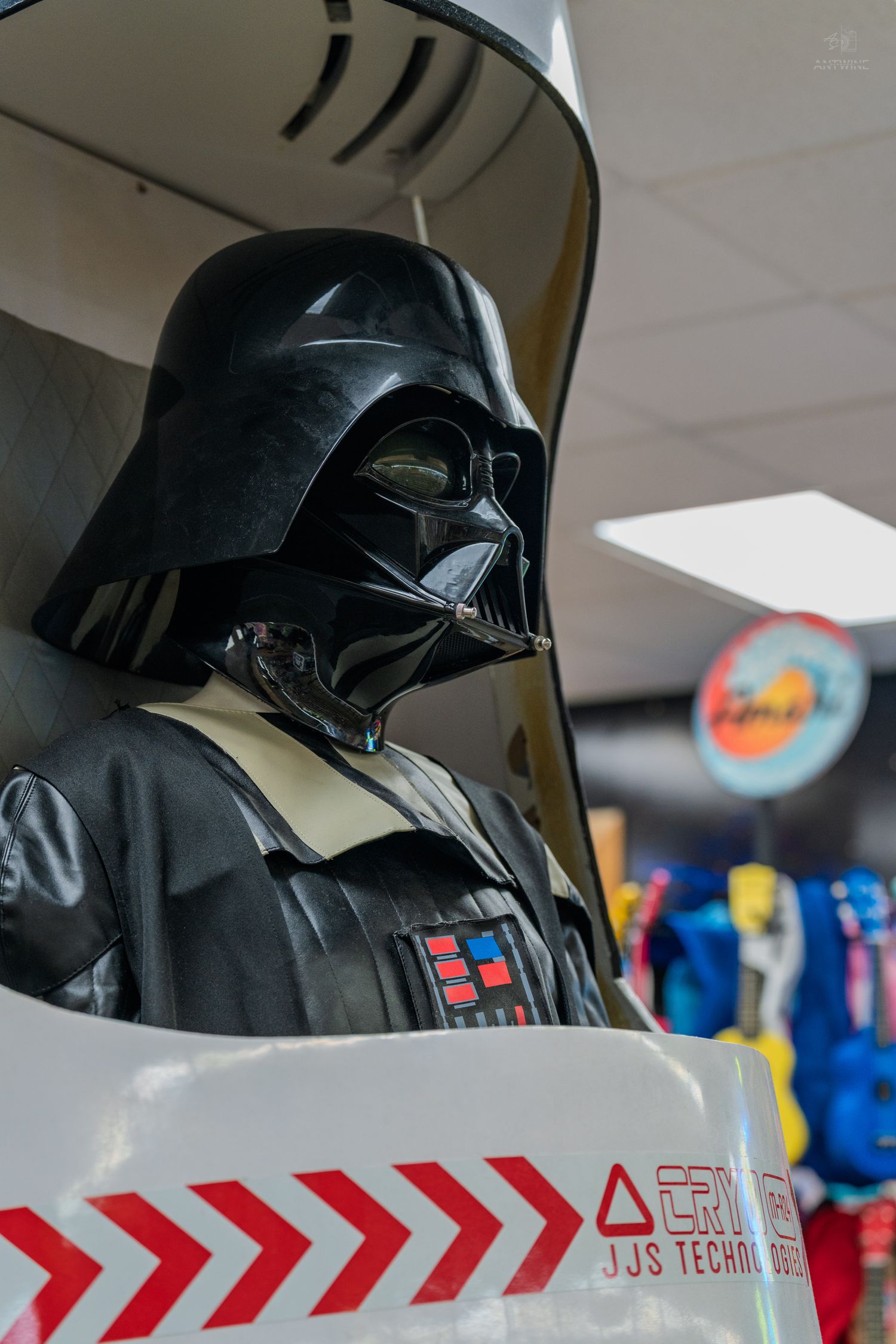 Life-size Darth Vader costume display at a retail store, featuring iconic black helmet and chest armor.