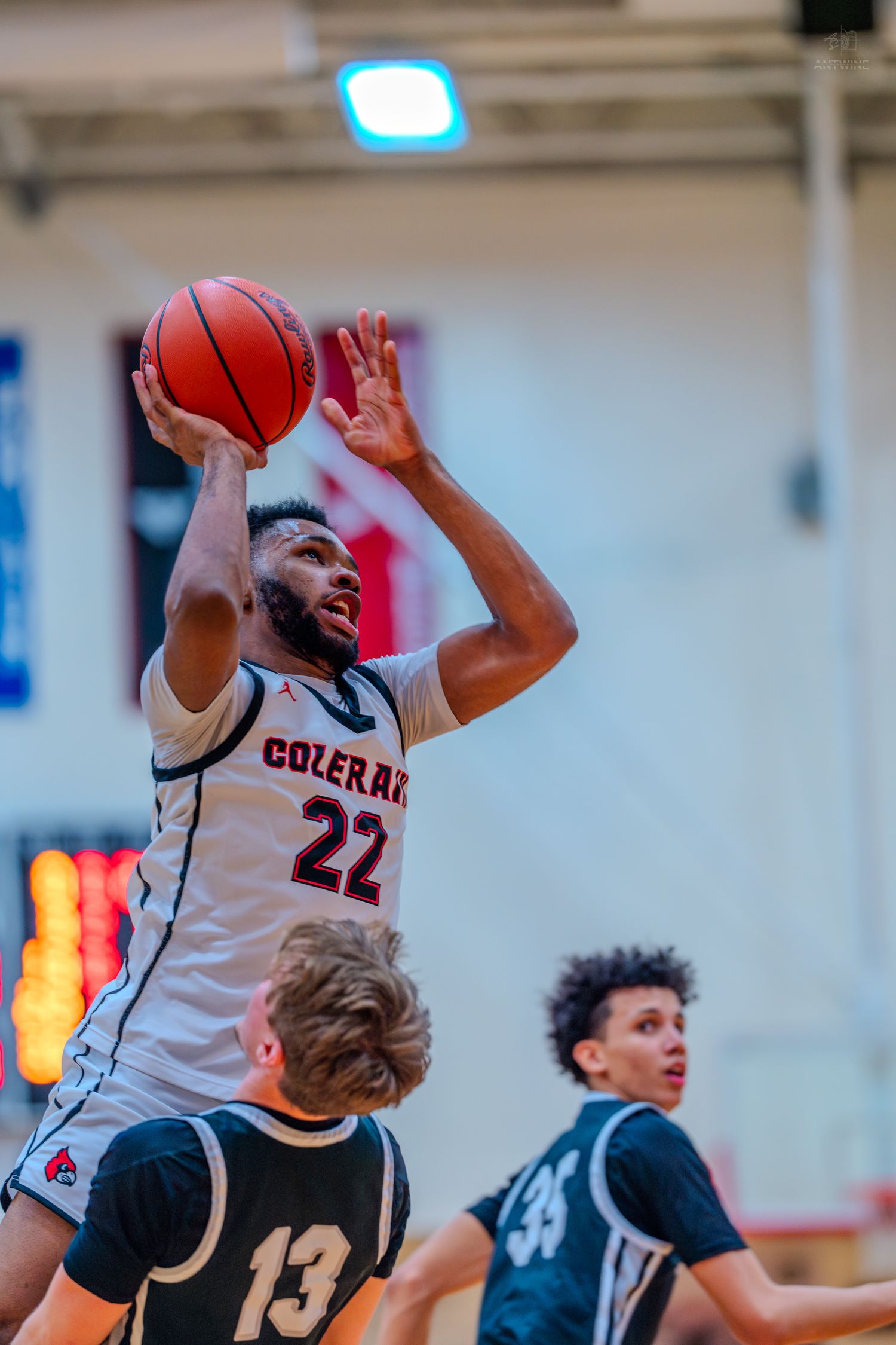 Colerain number 22 shoots over defenders during a high school basketball game.