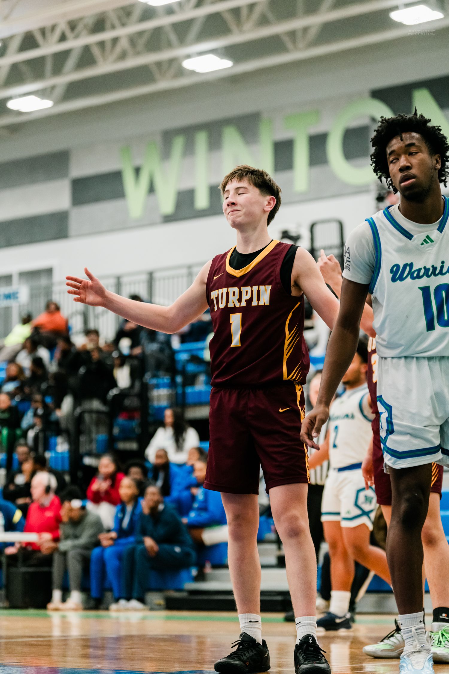 Turpin High School basketball player #1 reacts during a game against Winton Woods Warriors on the court.