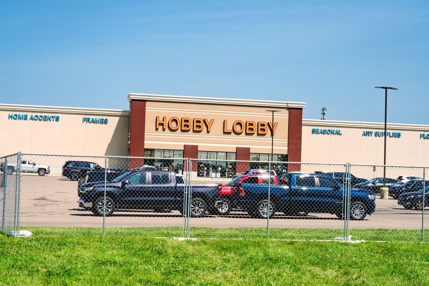 Hobby Lobby retail store exterior with large parking lot on a sunny day.