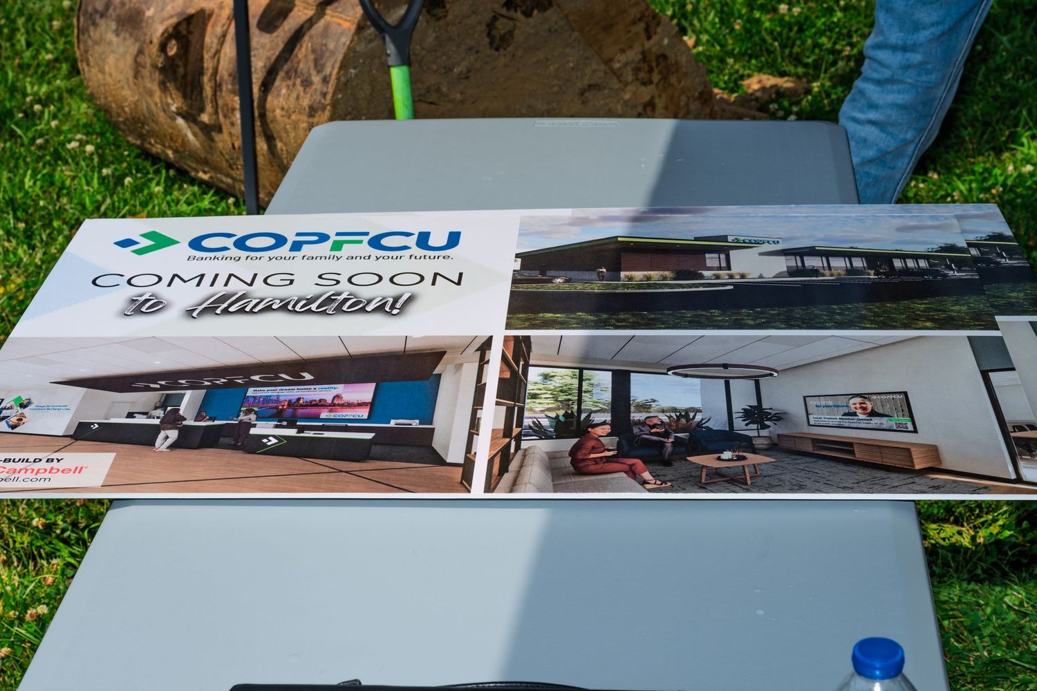 COPFCU credit union coming soon promotional sign displayed at a groundbreaking event.