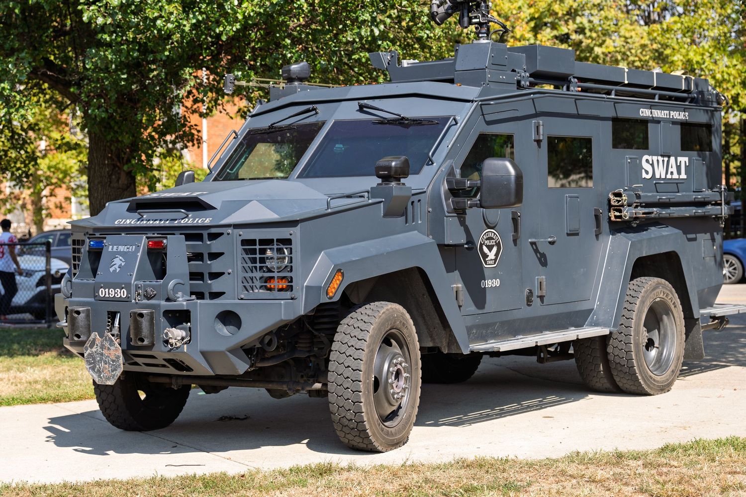 Black SWAT armored tactical vehicle parked outdoors, featuring heavy-duty bumper and SWAT lettering on the side.