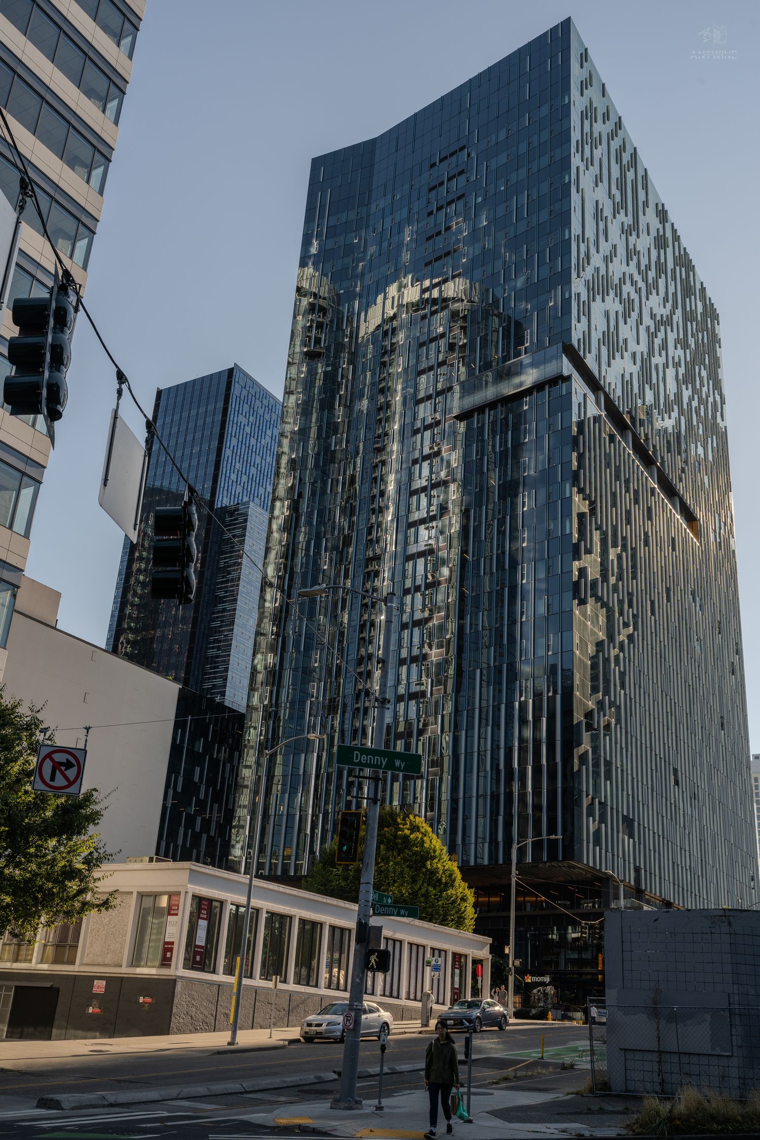 Modern glass skyscrapers reflecting blue sky in downtown Seattle at dusk.