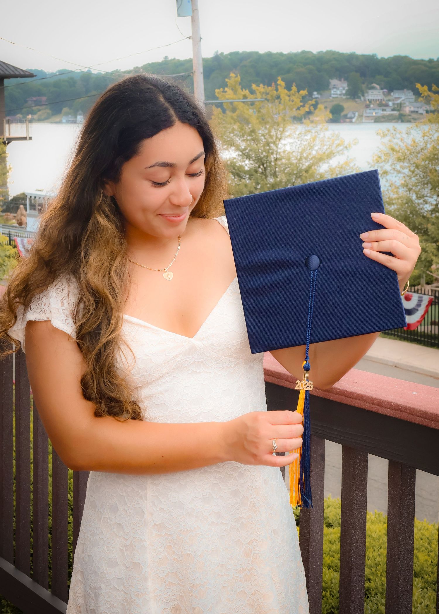 A female holding a graduation hat.