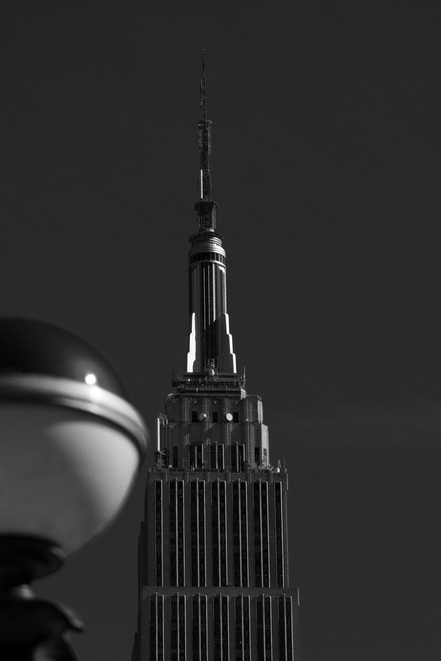 A medium close up photo of the Empire State Building in NYC.