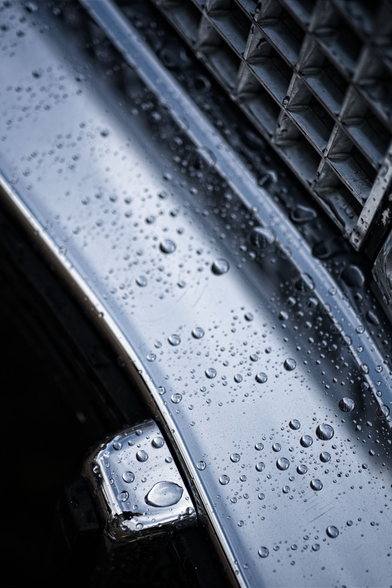 close up of a rainy Cadillac grill & bumper