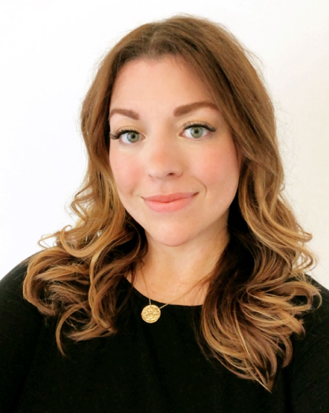 A person with wavy brown hair and playful expressions poses in a series of casual self-portrait style photos.