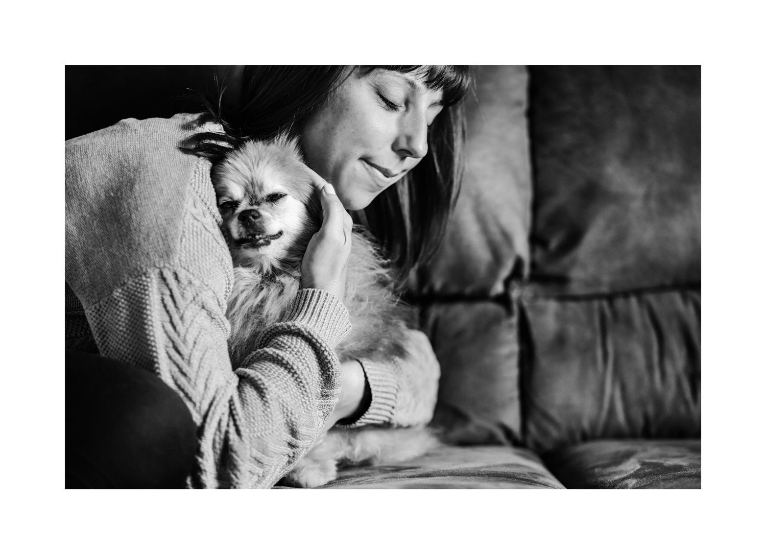 Woman hugging her Pomeranian dog