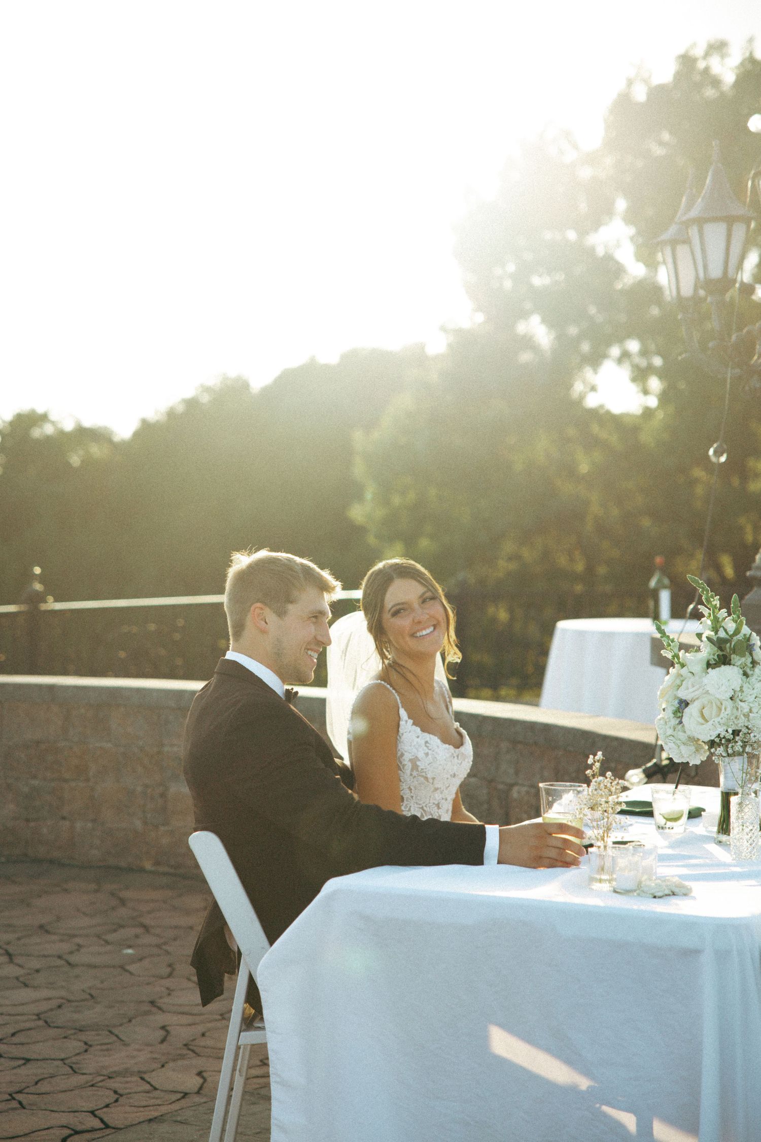 Newlyweds share a candid moment during their sunset reception dinner.
