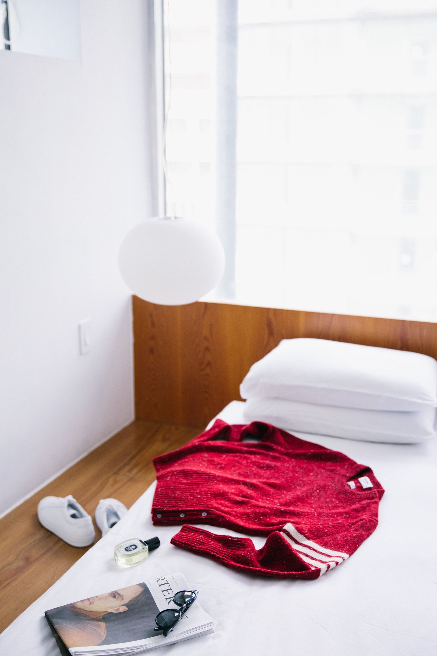Cashmere sweater on the bed of a Scandinavian inspired beds cape