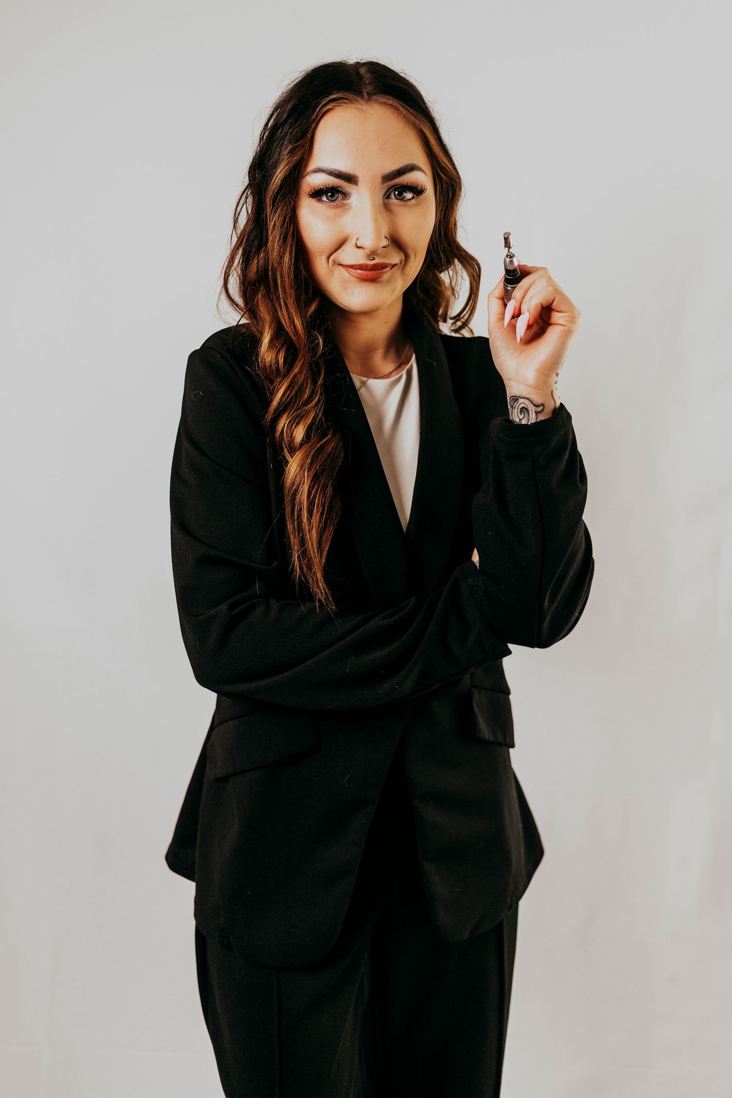 Professional portrait of someone in a black blazer against white background showing different poses and expressions.