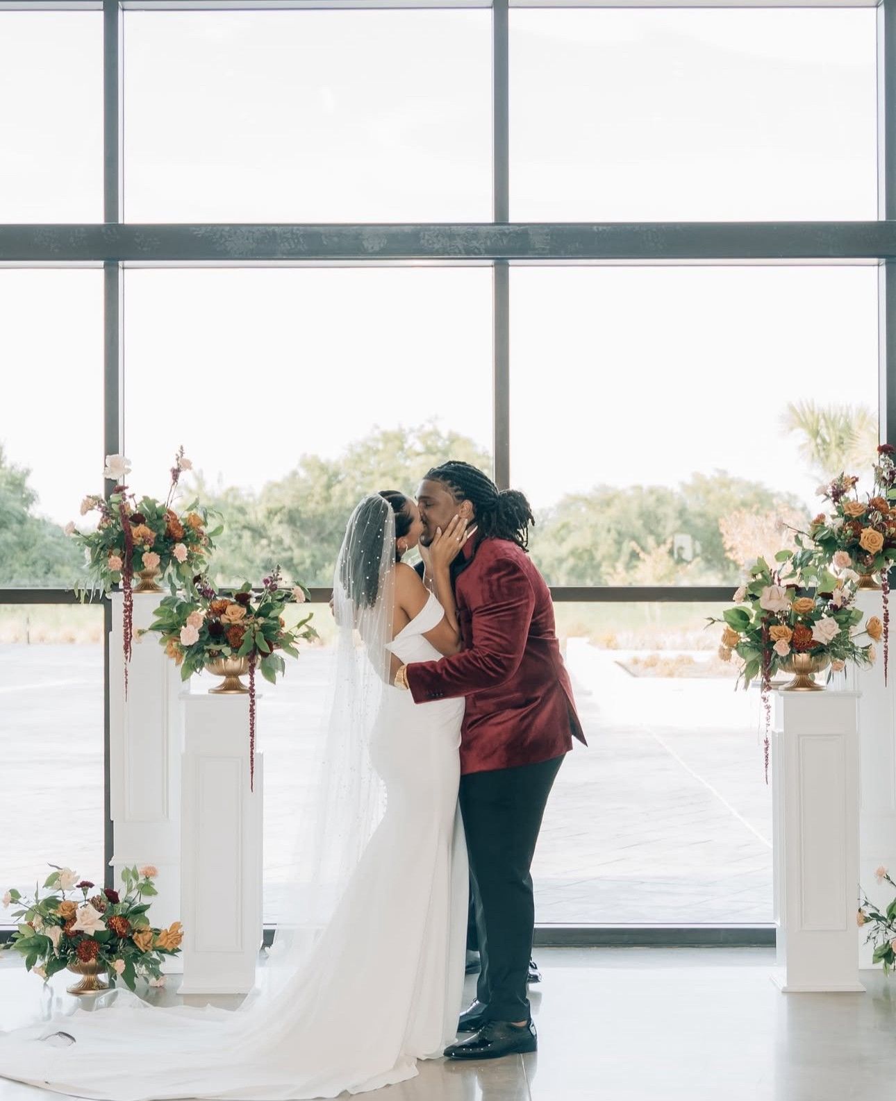 Burgandy wedding pillar flowers