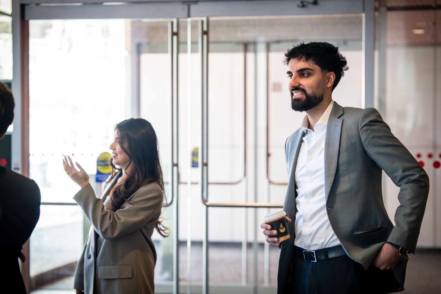 Professional speaker engaging with audience during a business presentation in modern venue.
