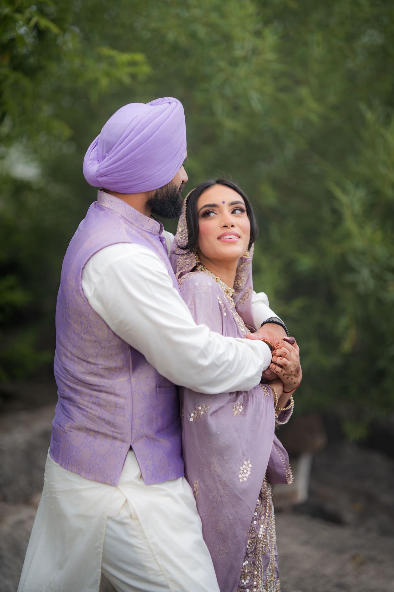 Couple in matching lavender outfits share an intimate moment during their photoshoot.