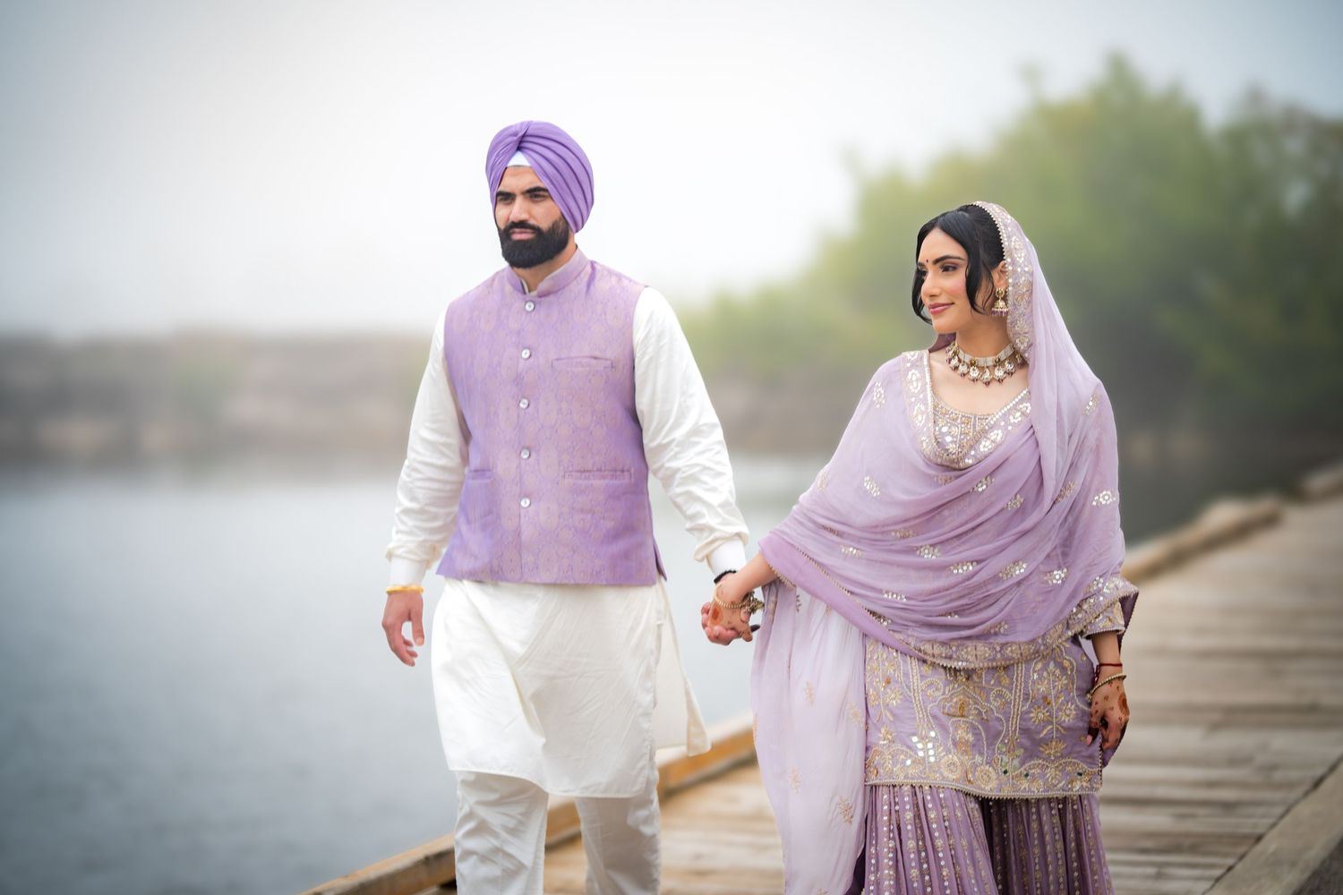 Romantic outdoor photoshoot featuring traditional Indian wedding attire in shades of lavender.