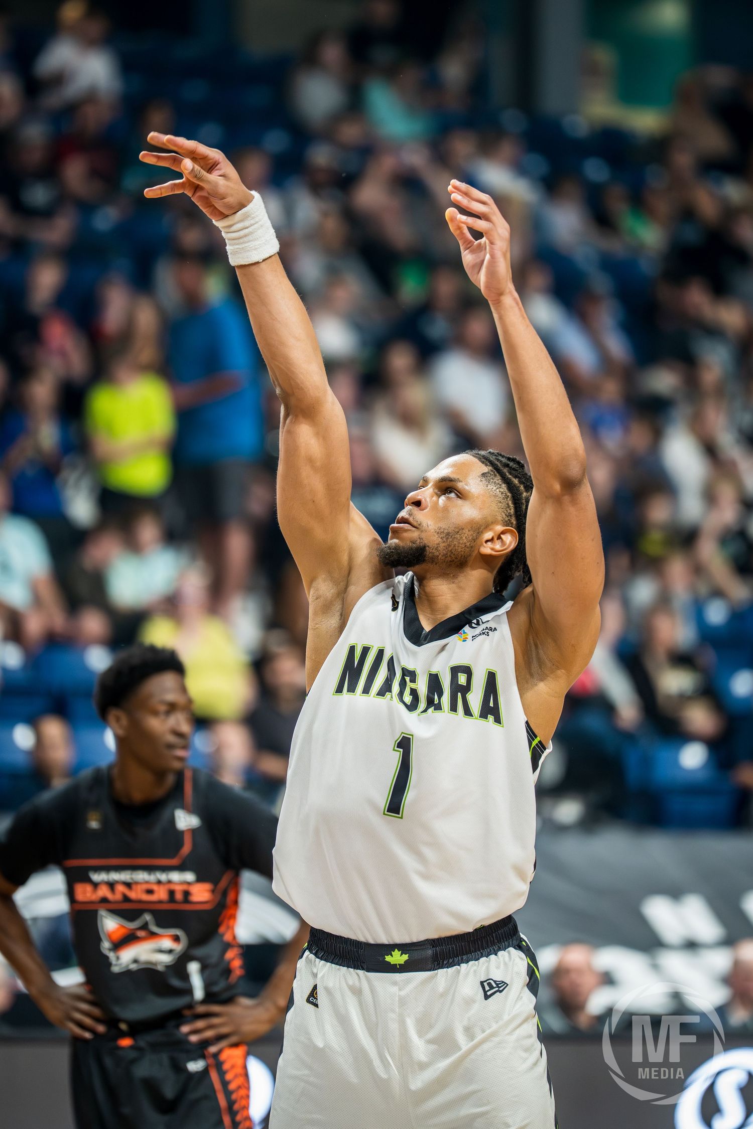 Niagara River Lions #1 releases a jump shot with perfect form as Vancouver Bandits defender watches.