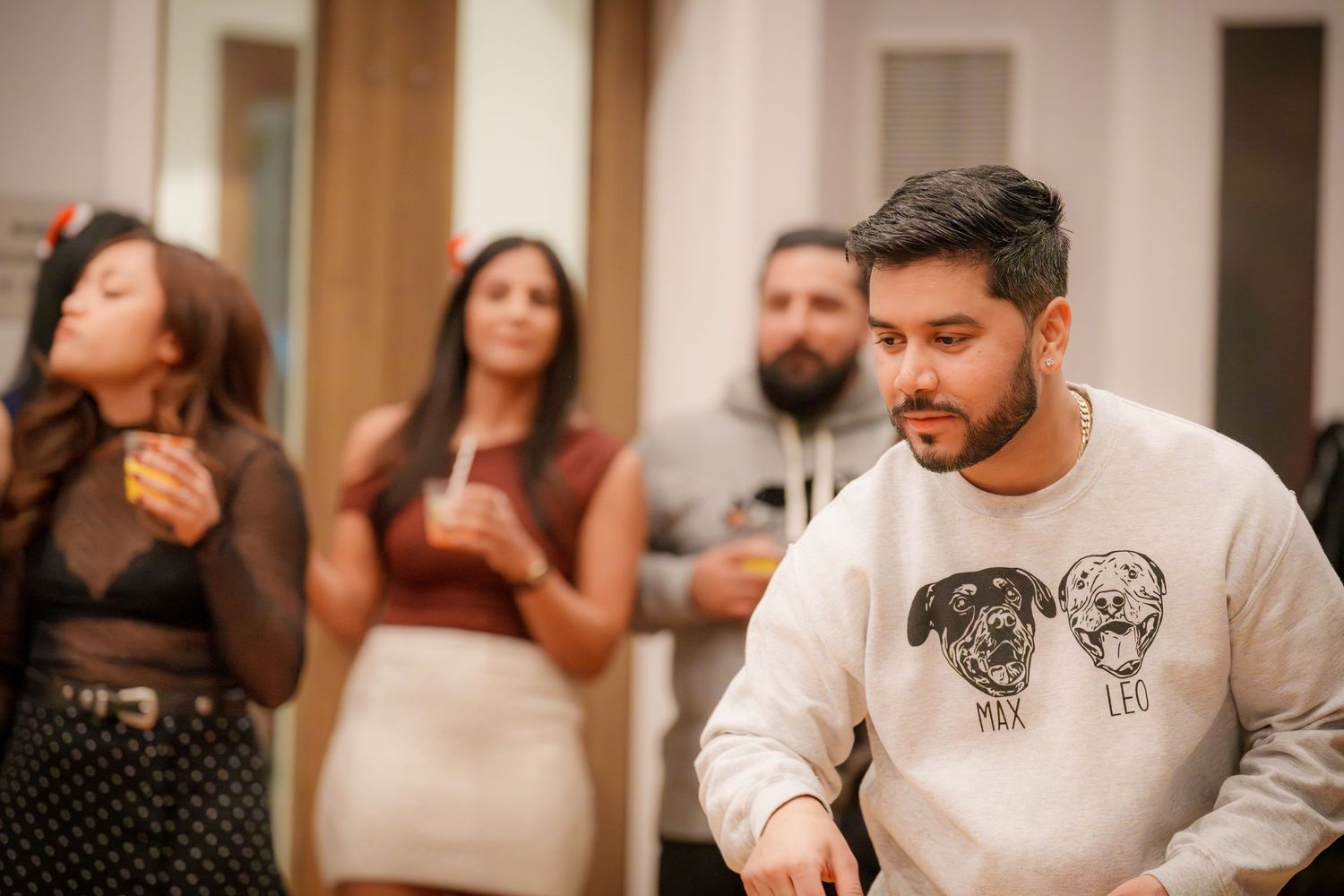 Group mingling and socializing at a casual indoor gathering.