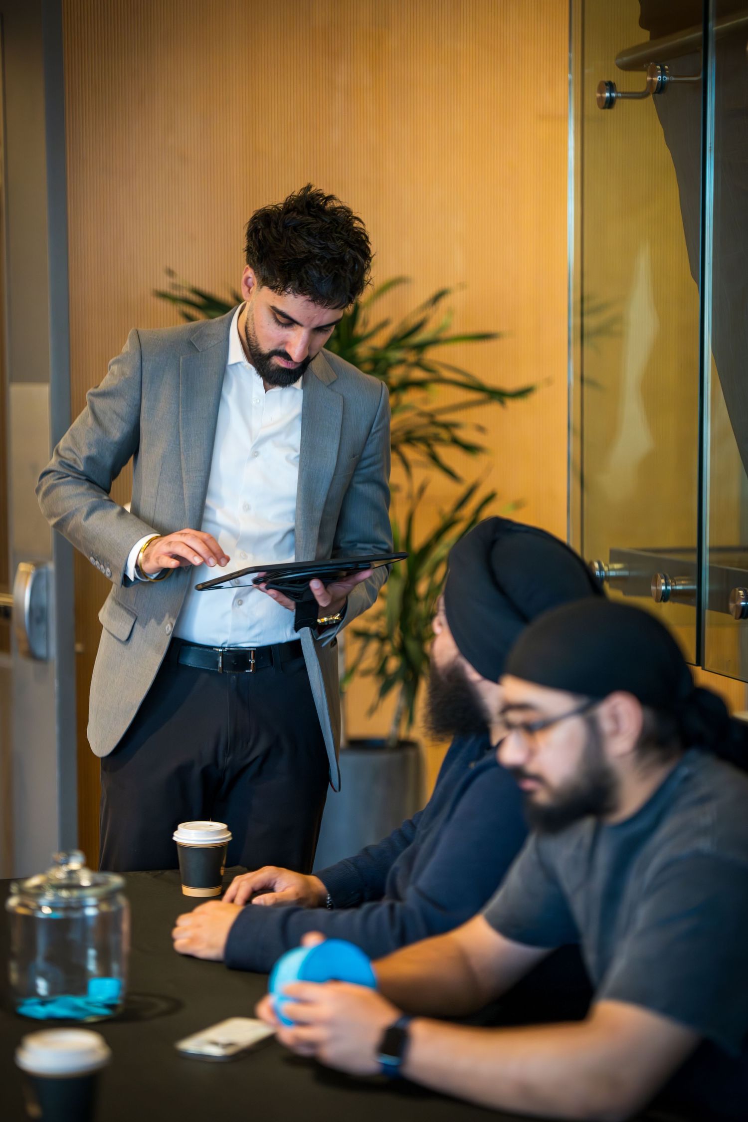 Business meeting in progress with professionals discussing around a conference table.