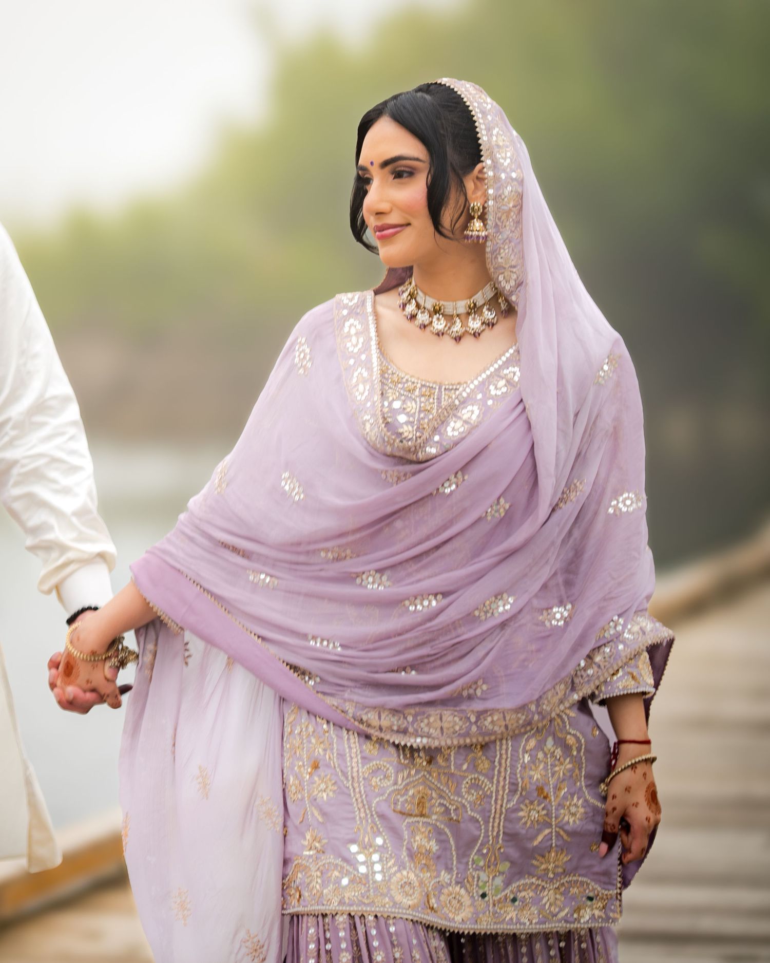Close-up details of lavender embroidered dupatta and traditional Indian bridal jewelry.