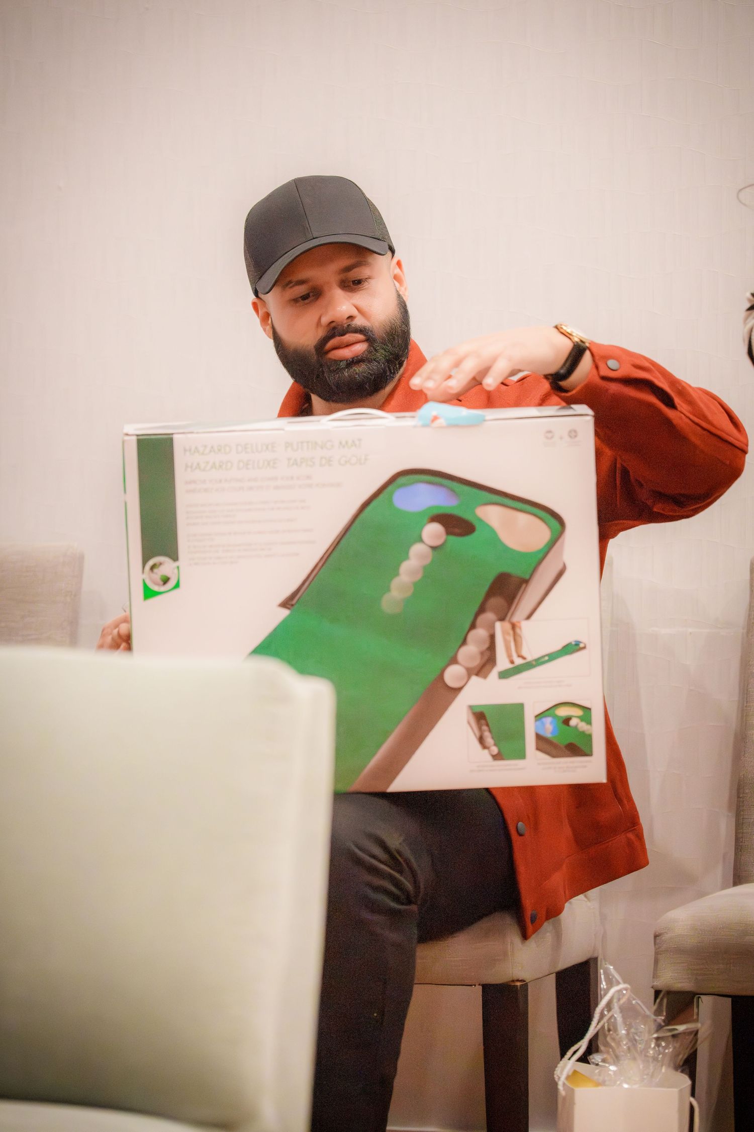 Person demonstrating a game or activity with green paper materials.