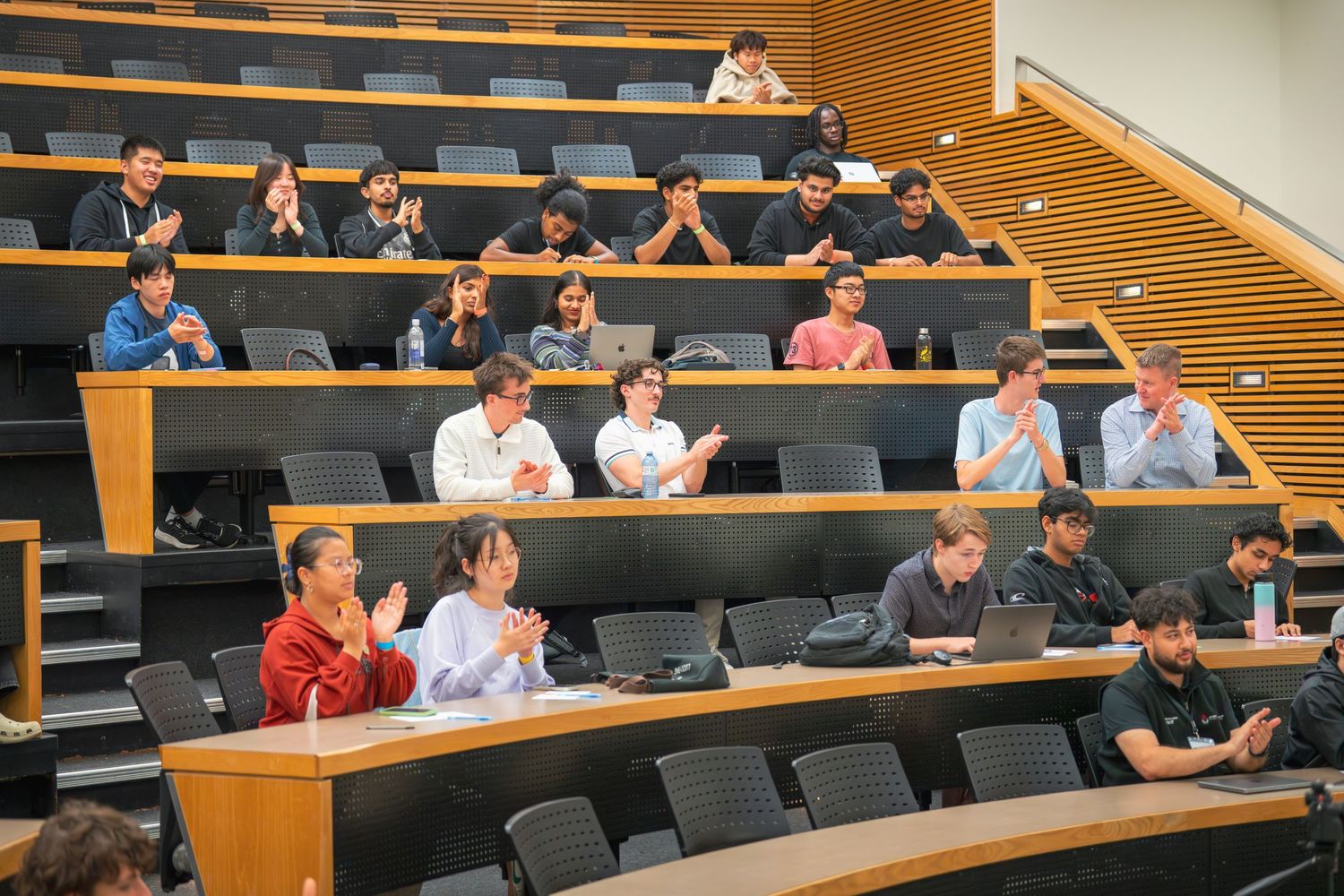 Audience members sitting in tiered seating during an educational presentation.