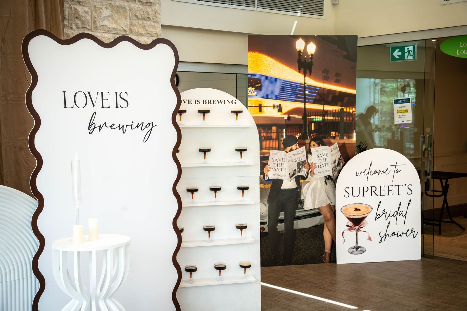 White decorative signs with cocktail graphics and text displayed in a restaurant or bar interior setting.