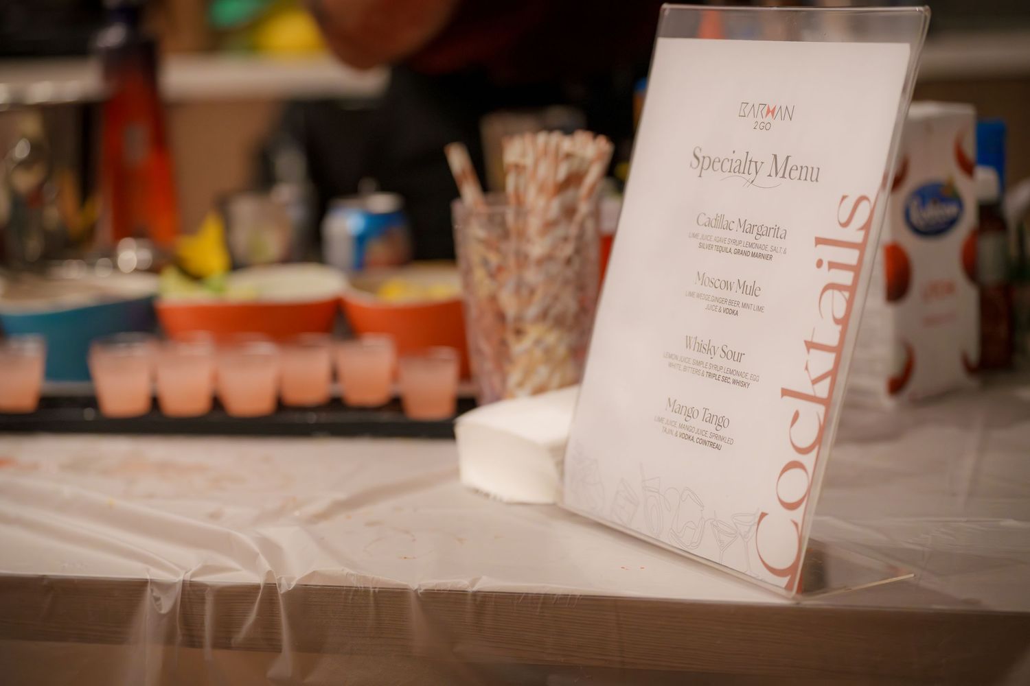 Table setup with event menus and party supplies at an indoor venue.