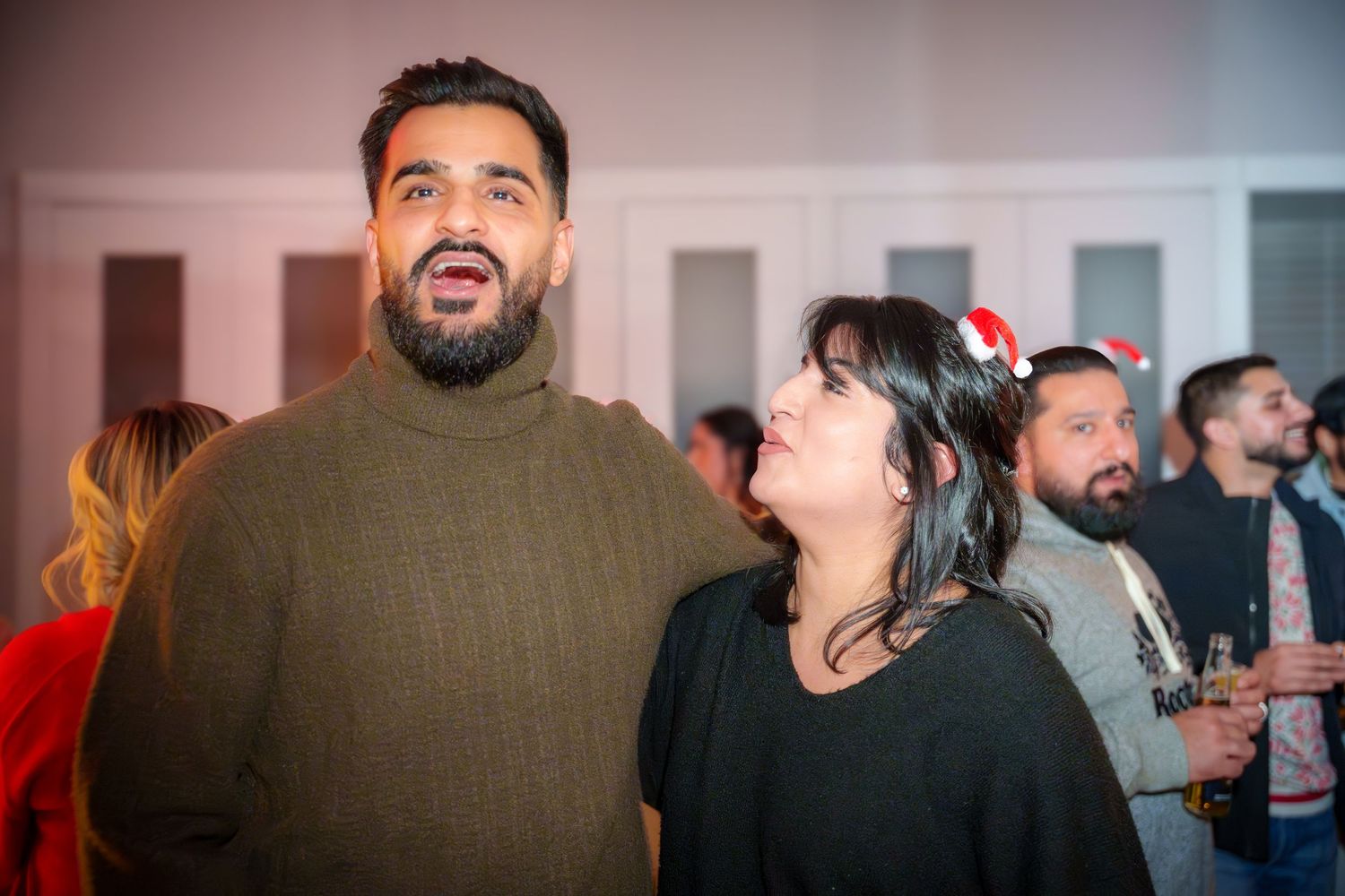 Party guests enjoying themselves during an evening celebration.