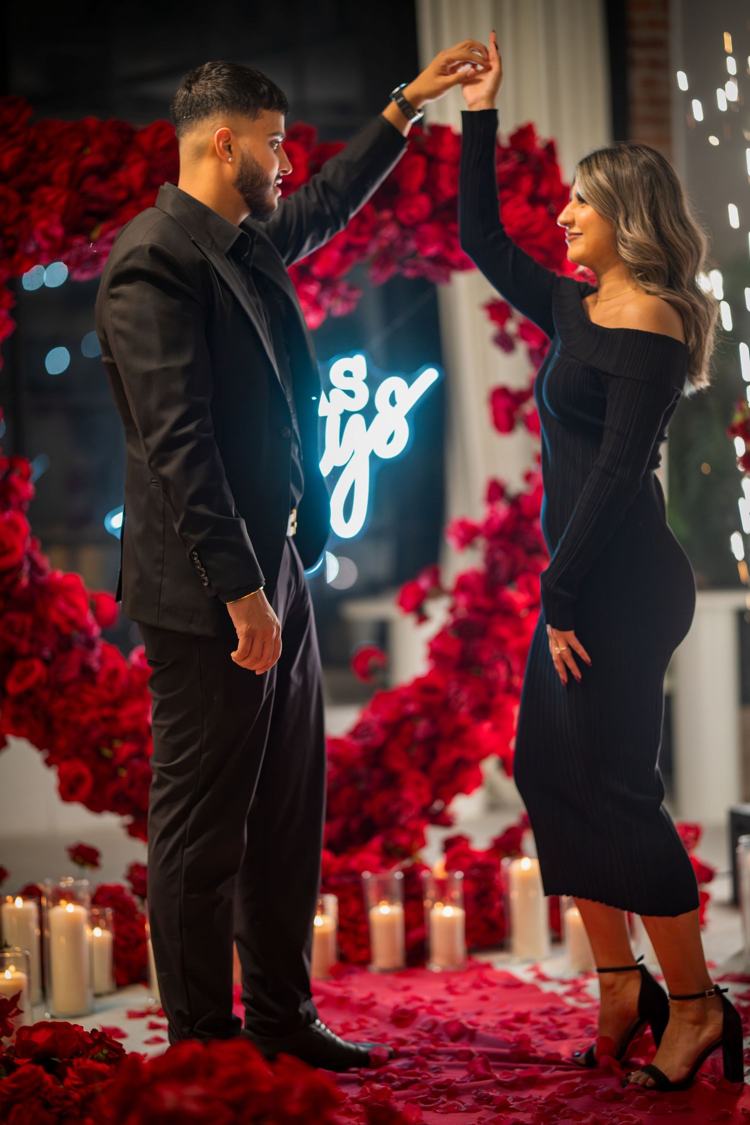 A sequence showing a surprise proposal moment with red roses and candles creating an intimate atmosphere.