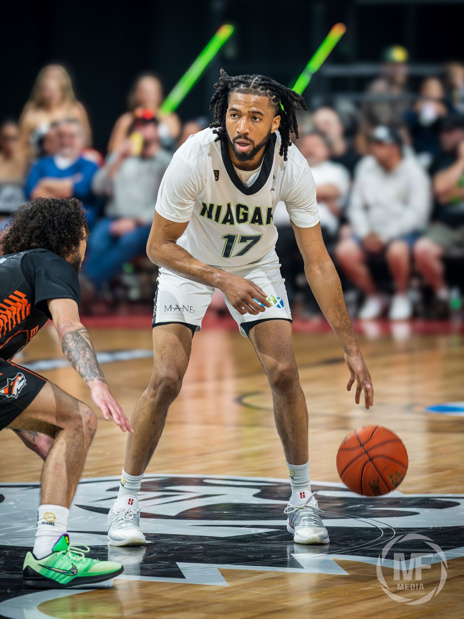 Niagara River Lions player #17 in defensive stance during a CEBL basketball game.