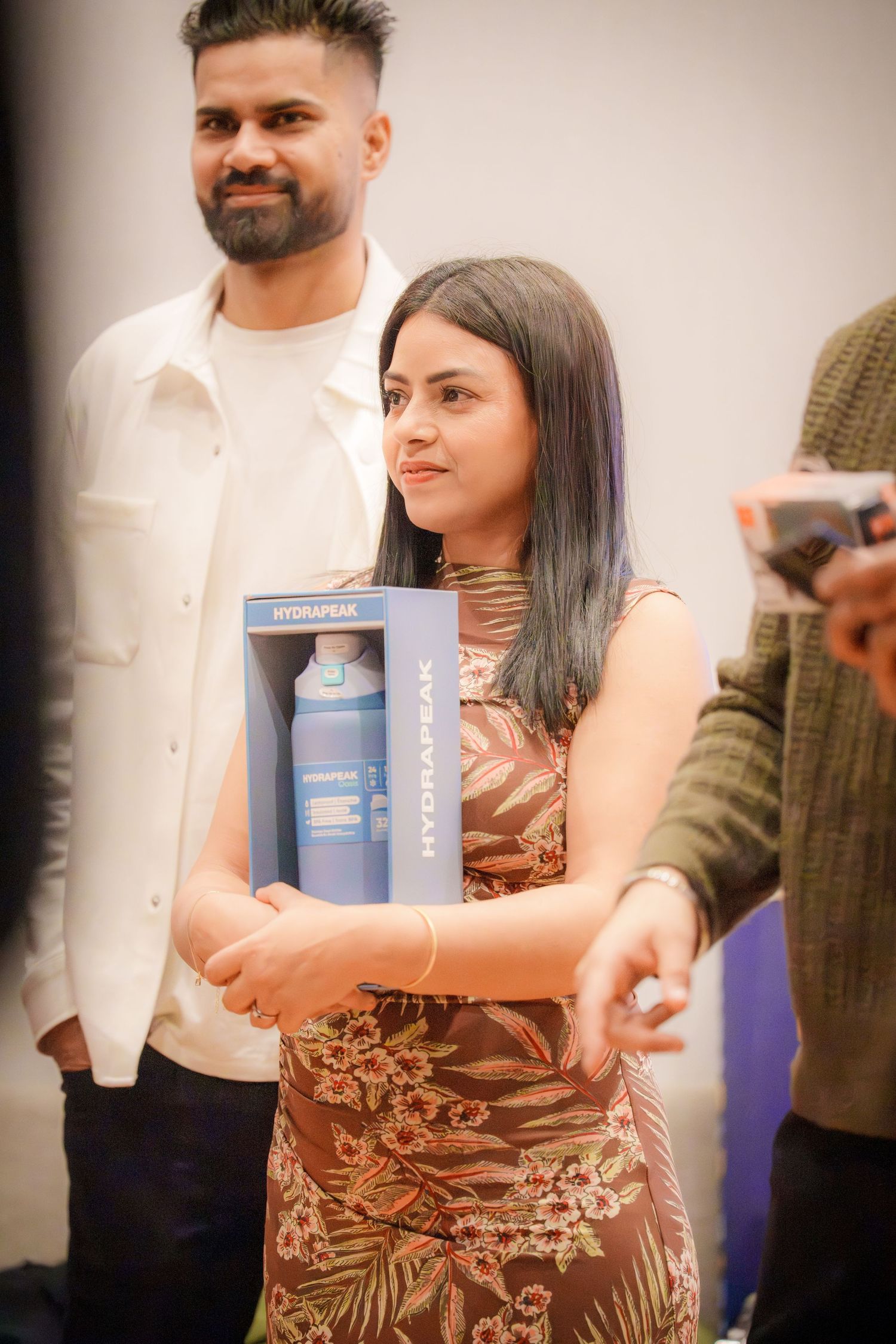 People holding books and posing together at a social gathering.