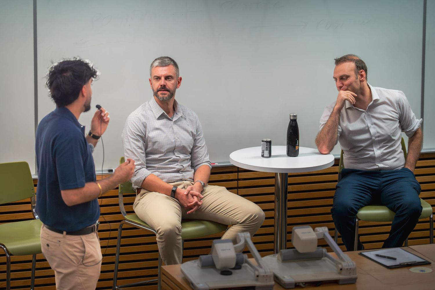 Several people sit around a conference table during a business discussion.