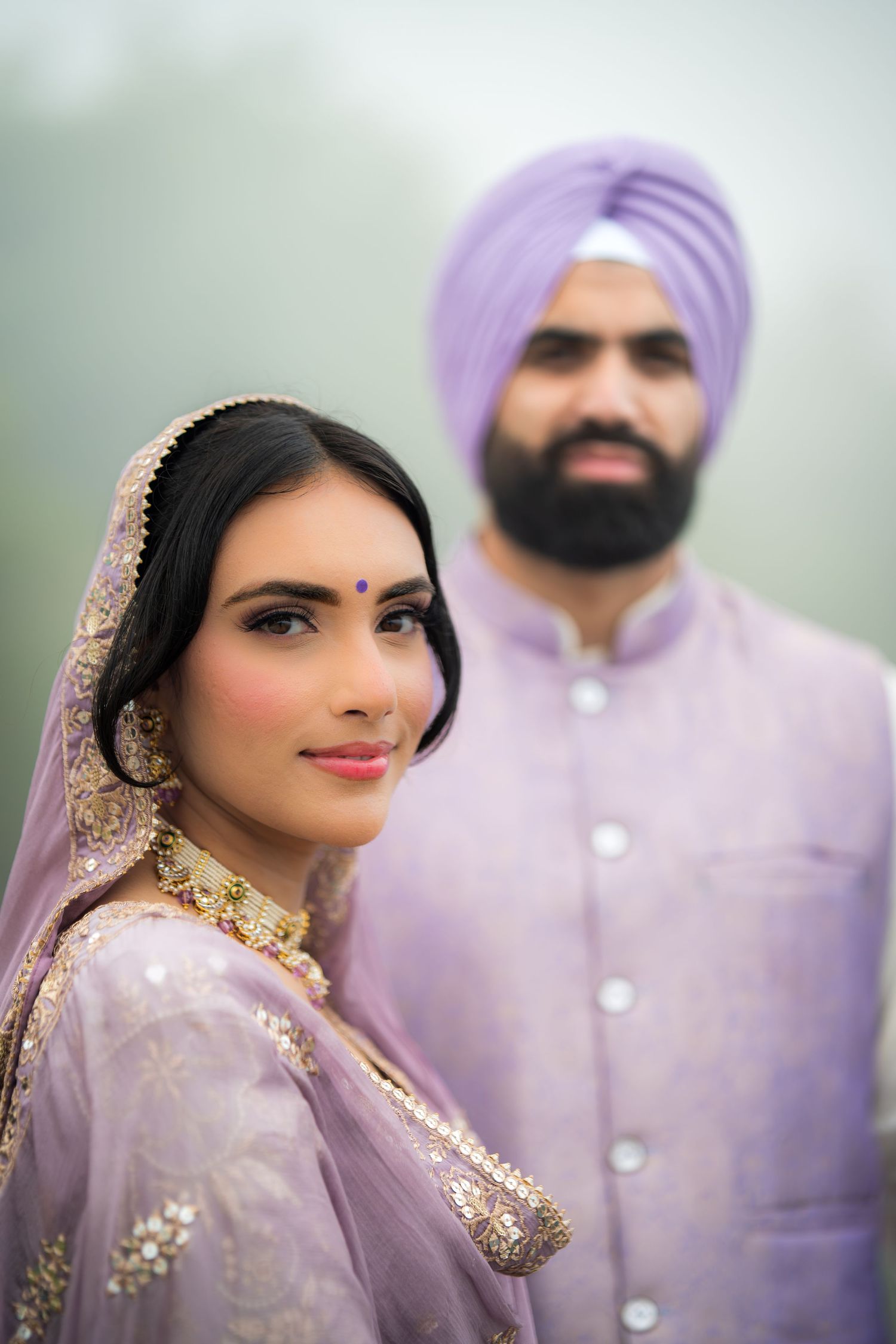 Elegant bridal portrait showcasing traditional Indian makeup and lavender embellished outfit.